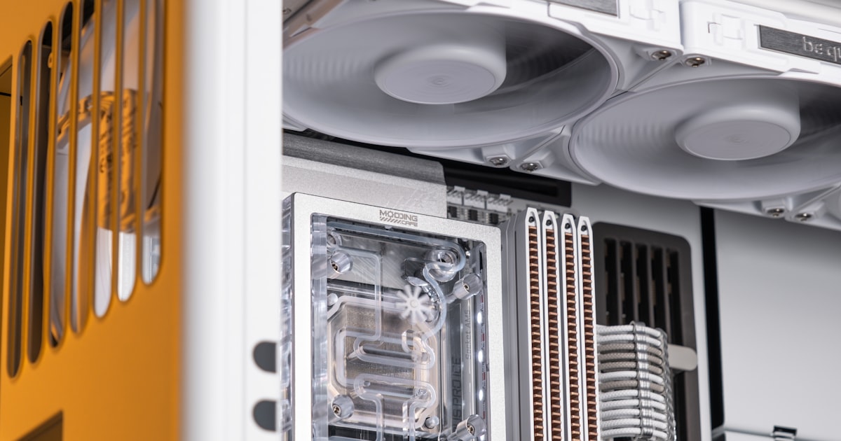 Close-up of a white computer with cooling fans.