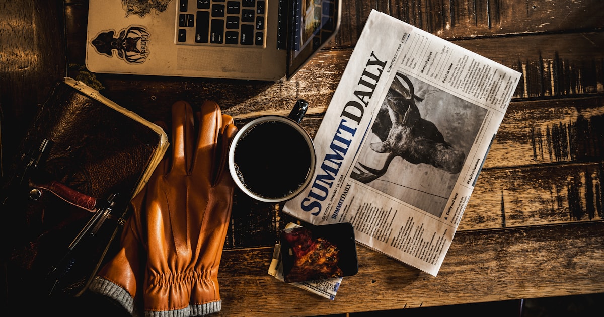 a newspaper and a pair of gloves on a table