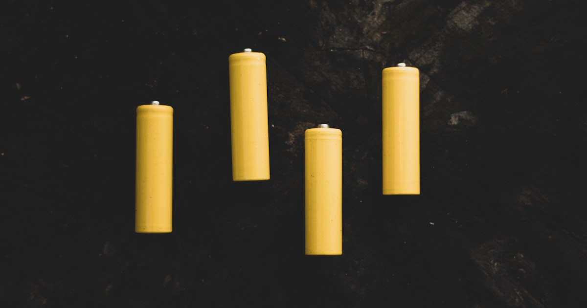 yellow pillar candles on black surface