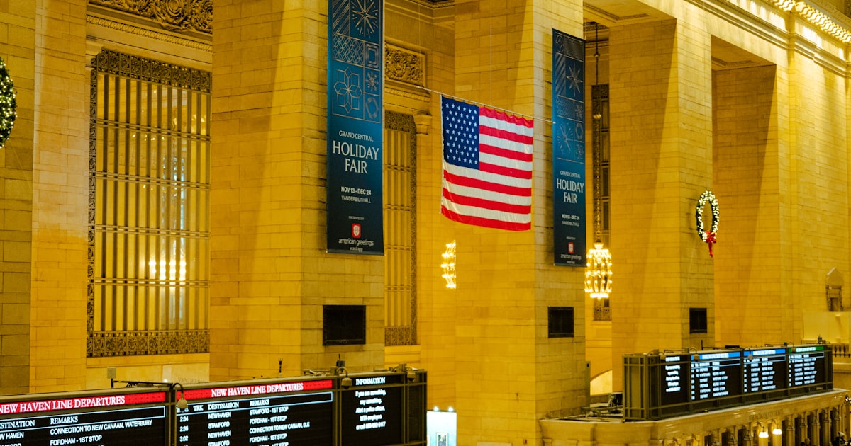 a train station with a lot of people walking around