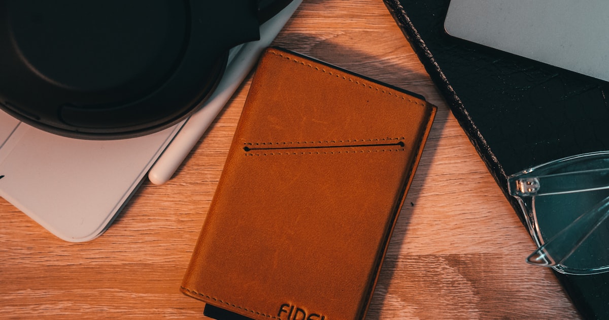 a brown leather case sitting on top of a wooden table