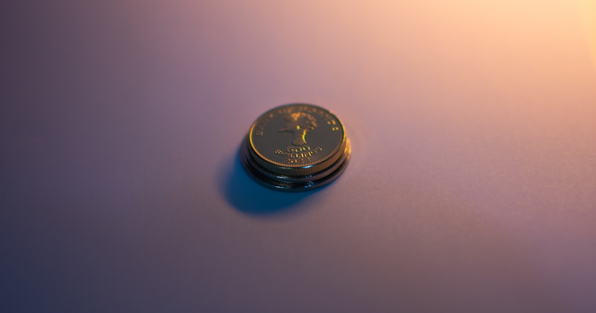 A stack of coins reflects light.