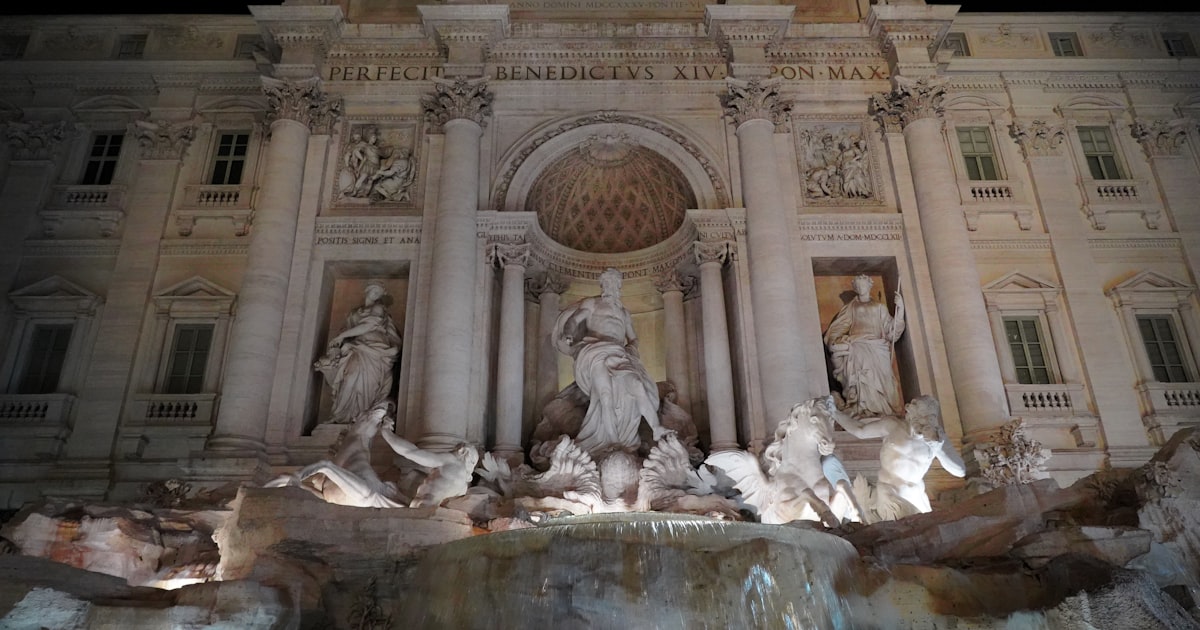 a large building with a fountain in front of it