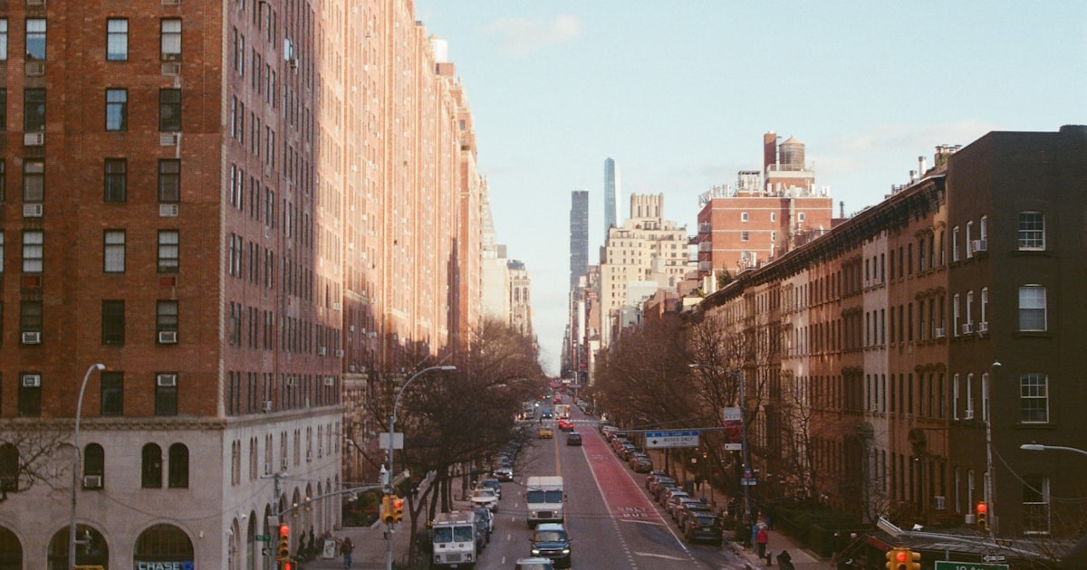 City street with buildings and traffic on a sunny day
