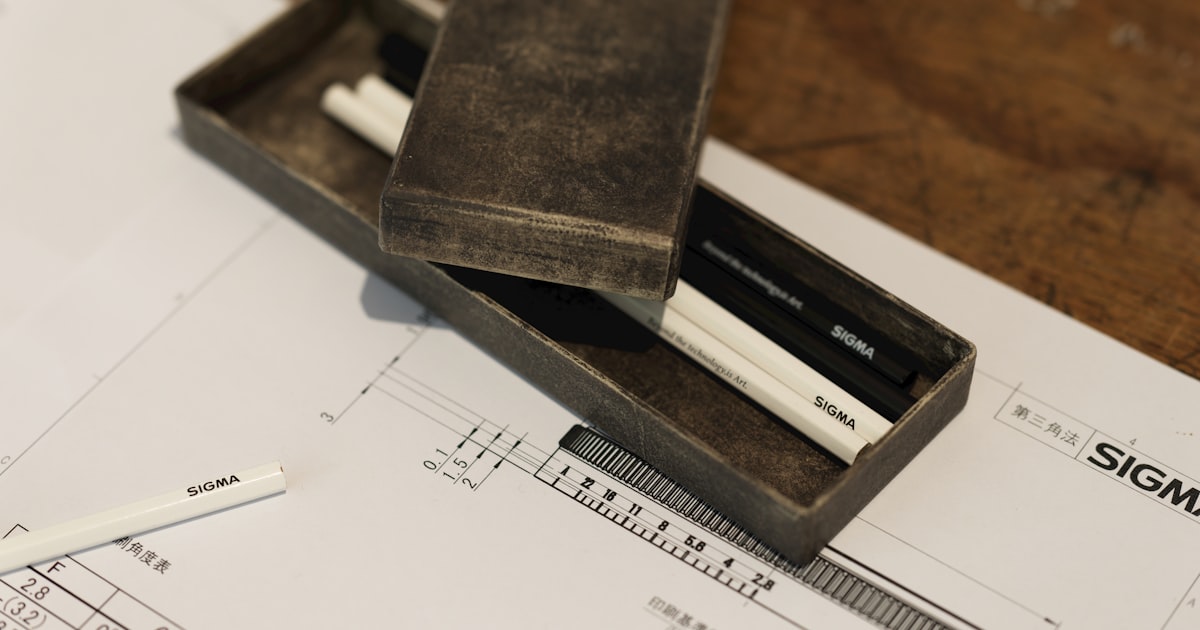 A pencil and ruler sitting on top of a piece of paper
