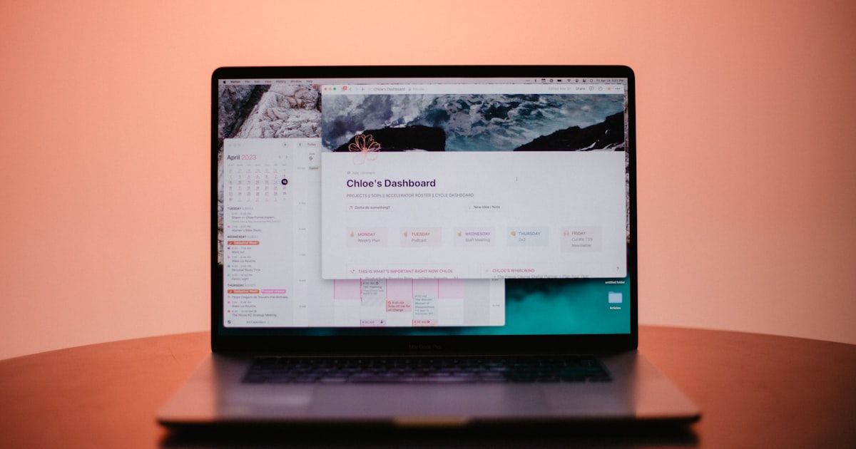 a laptop computer sitting on top of a wooden table