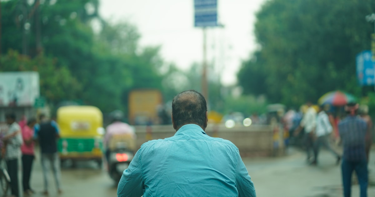 a person riding a bicycle on a busy street