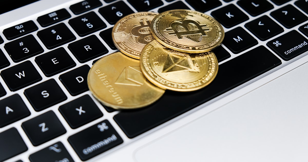 a group of gold coins on a keyboard