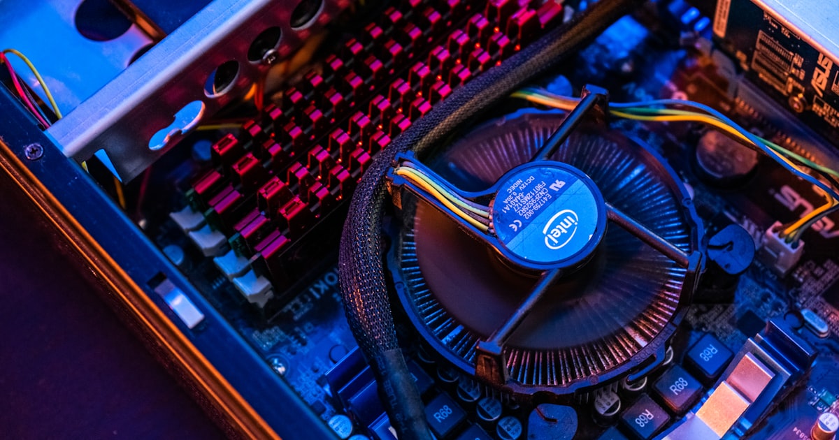 blue and black typewriter on brown wooden table