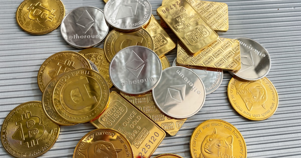 a pile of gold and silver coins sitting on top of a table