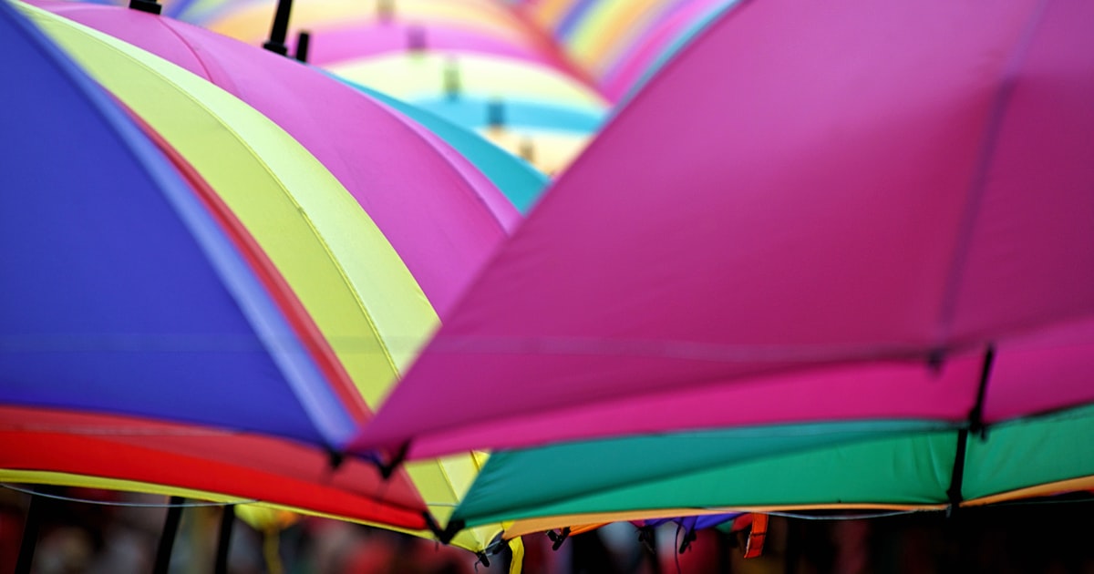 a group of colorful umbrellas hanging in a row