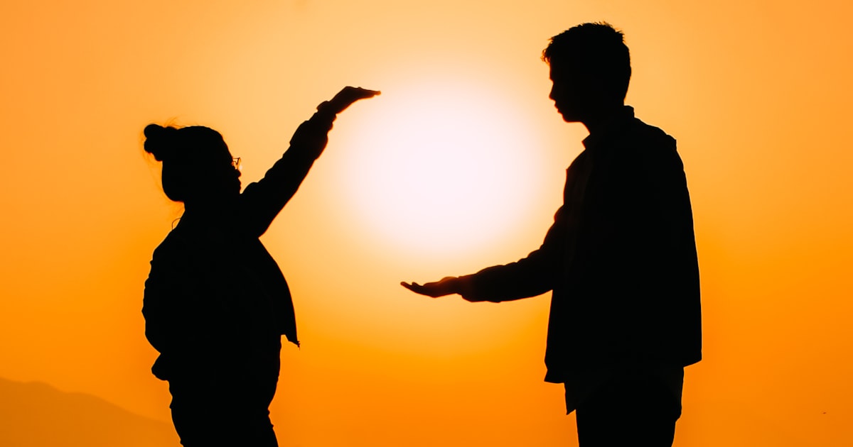 silhouette of man raising his hands