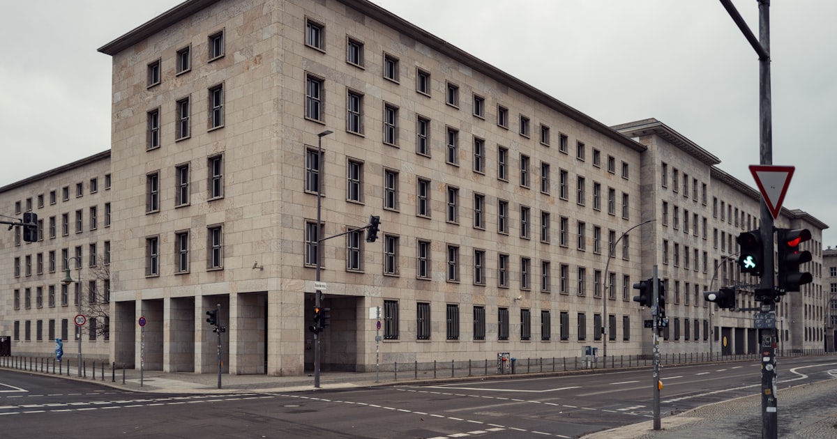 Large brutalist building on a city street corner.