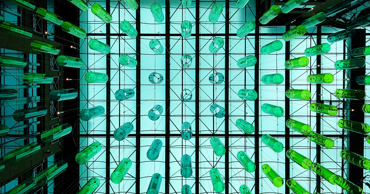 a very large room with a lot of green objects in it