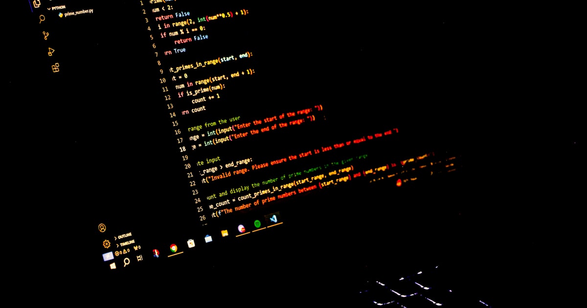 a computer screen with a keyboard in the dark