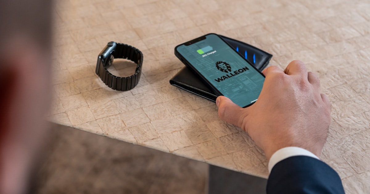 a man holding a smart phone next to a smart watch