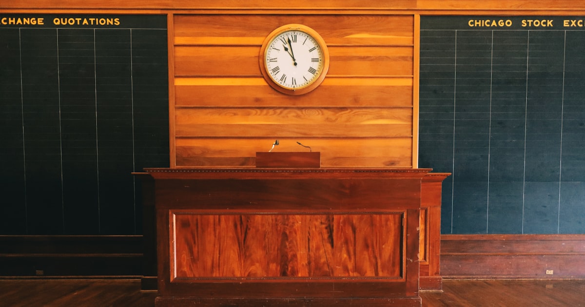 An old stock exchange room with clock and quotations.