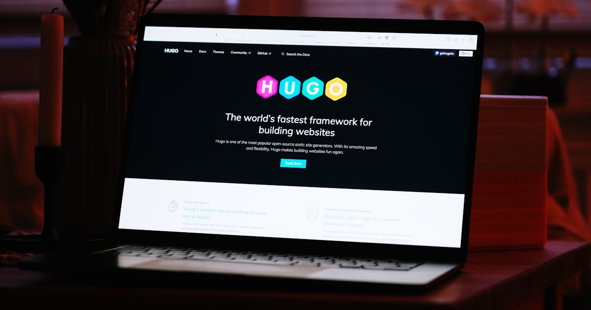 A laptop computer sitting on top of a wooden desk