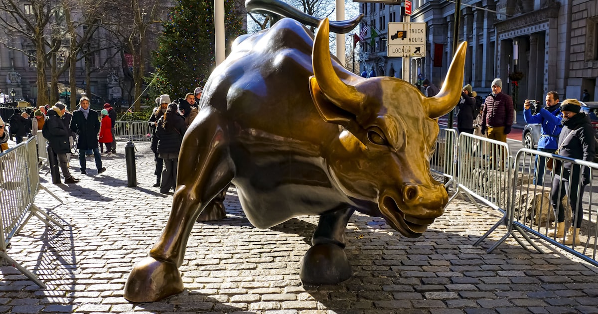 a statue of a bull on a brick street