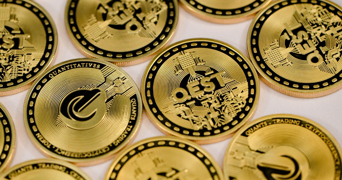 a pile of gold coin sitting on top of a table