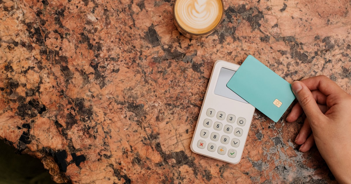 a calculator and a cup of coffee on a table