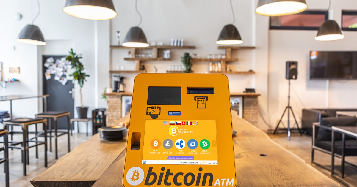 a bitcoin atm sitting on top of a wooden table