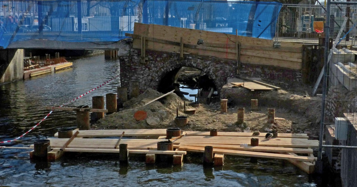 a bridge over a body of water under a blue bridge