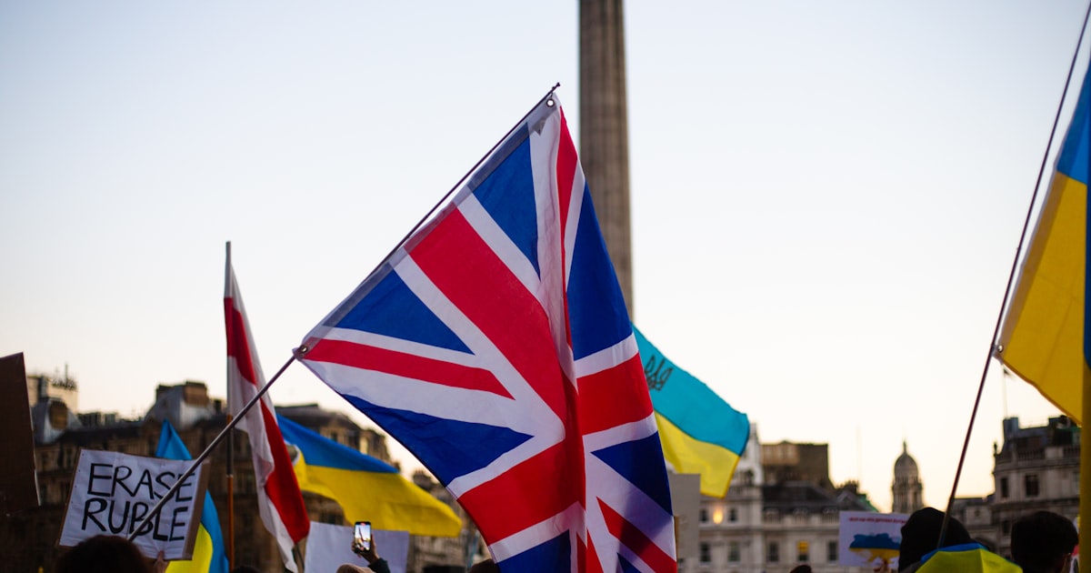 a group of people holding flags and signs