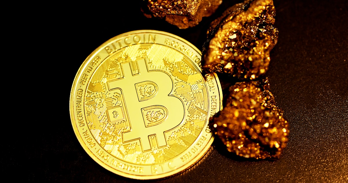 a bitcoin sitting on top of a pile of gold nuggets