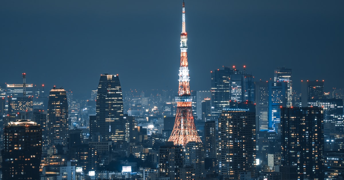 Illuminated tokyo tower and city skyline at night