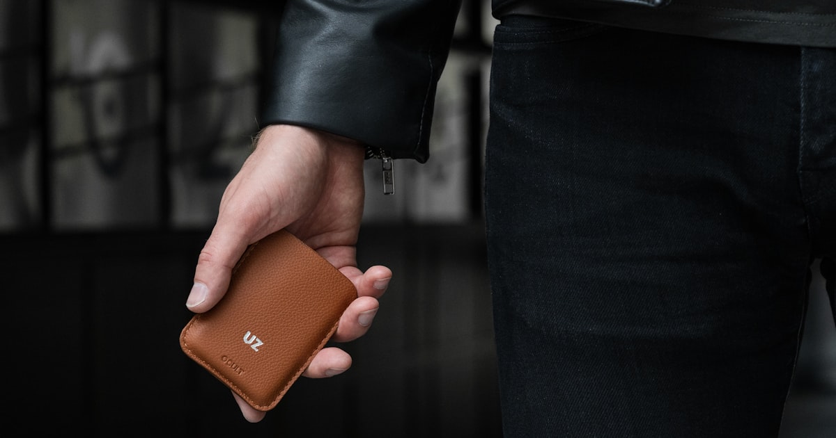 a person holding a wallet in their hand