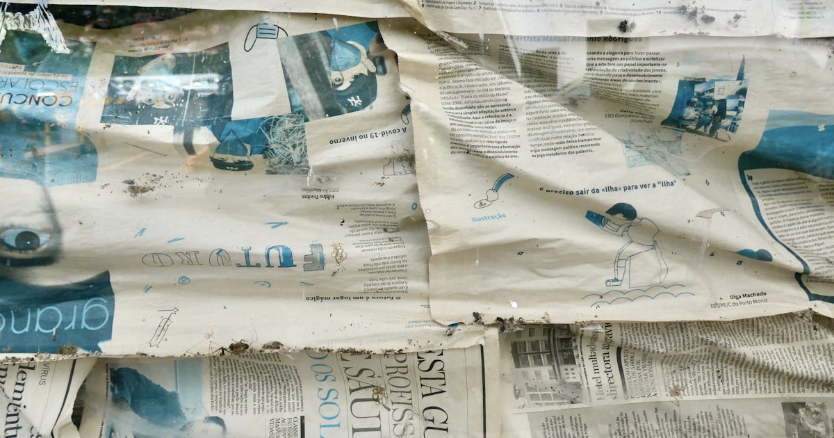 a pile of newspapers with blue images on them