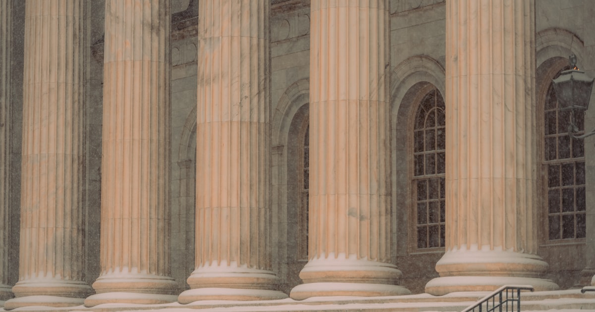 a man sitting on a bench in front of a building