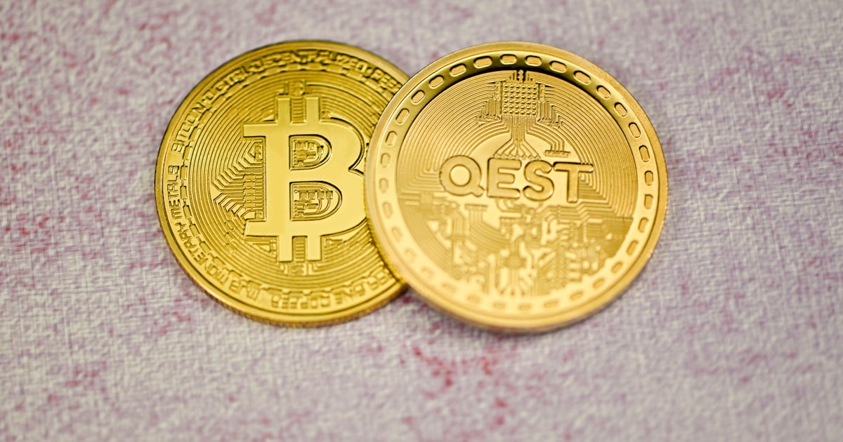 a close up of two gold bitcoins