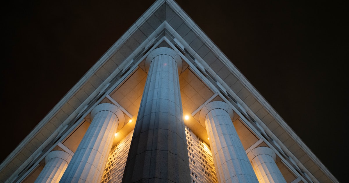 a very tall building with some lights on it's sides