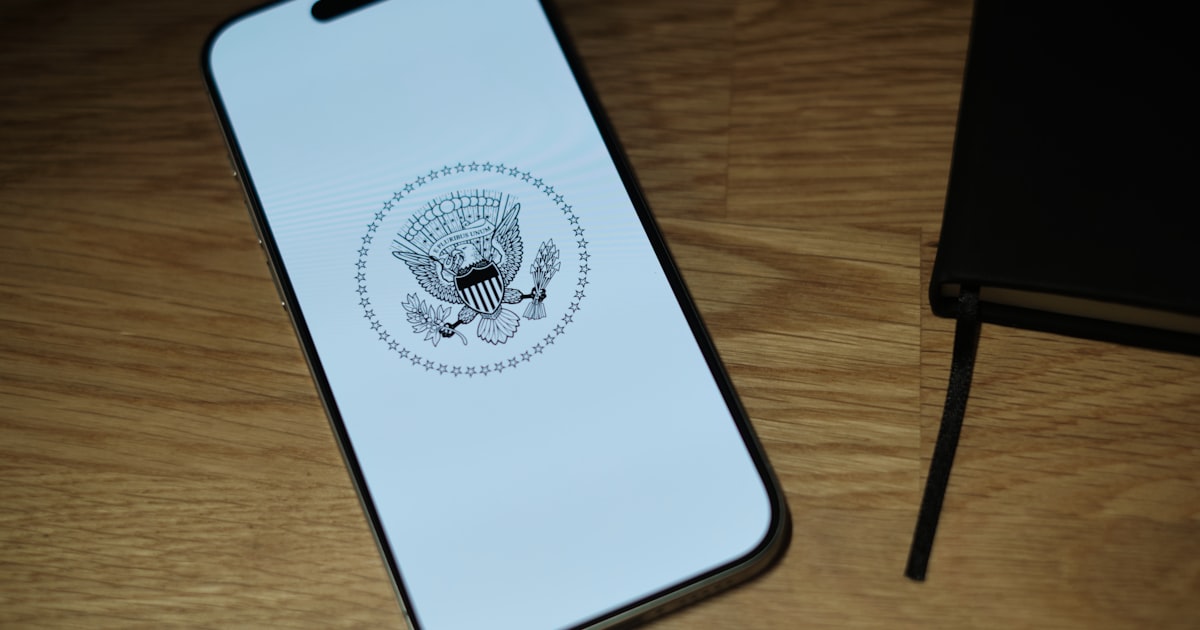 A white iPhone sitting on top of a wooden table