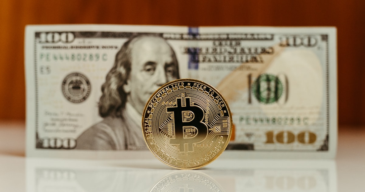 a bitcoin sitting on top of a stack of money