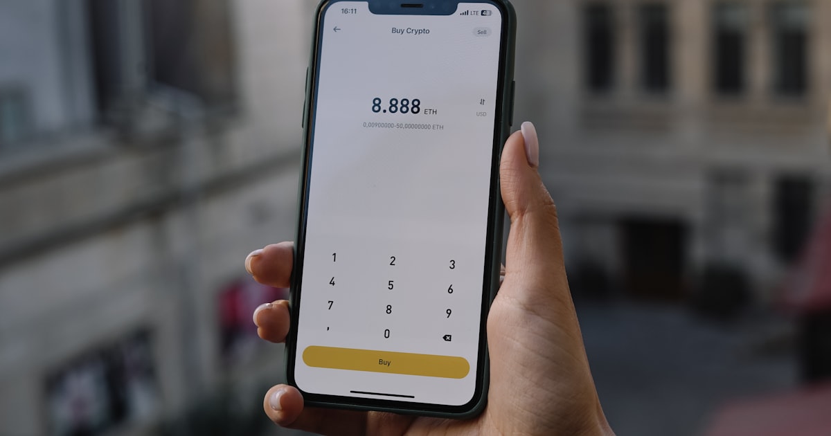 a person holding a cell phone in their hand