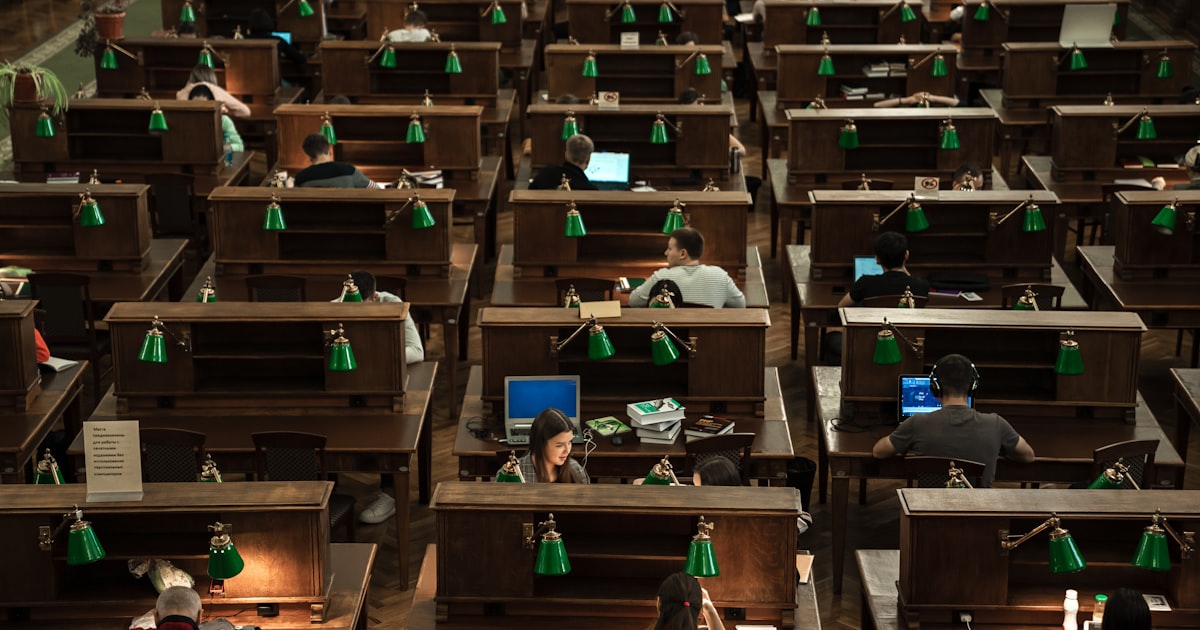a room filled with lots of desks covered in computers