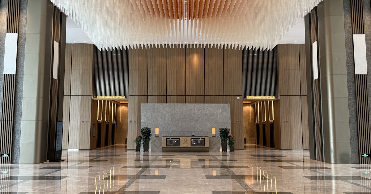 Modern lobby with marble floors and decorative ceiling