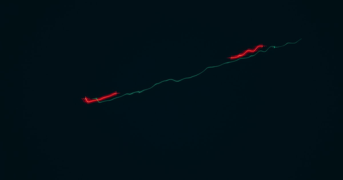 a plane is flying in the sky at night