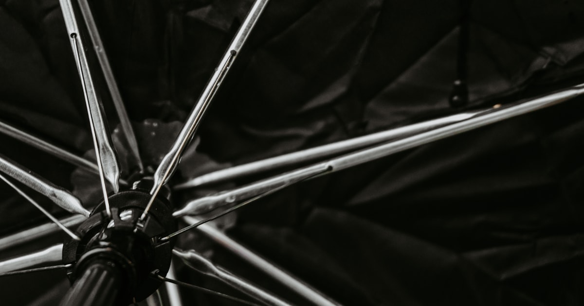 black umbrella on black textile