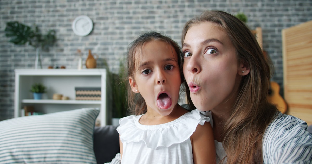 Mother and daughter making funny faces together