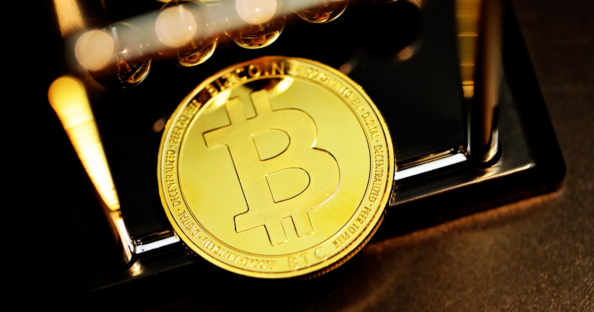 gold round coin on black surface