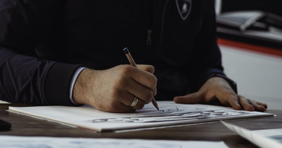 man writing on paper