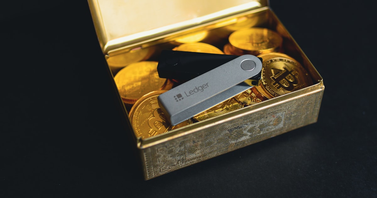 a swiss army knife sitting in a box of gold coins