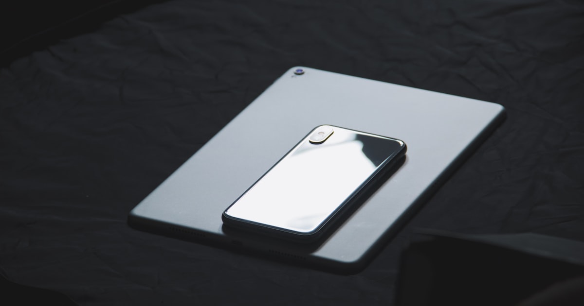space gray iPhone X on tablet computer