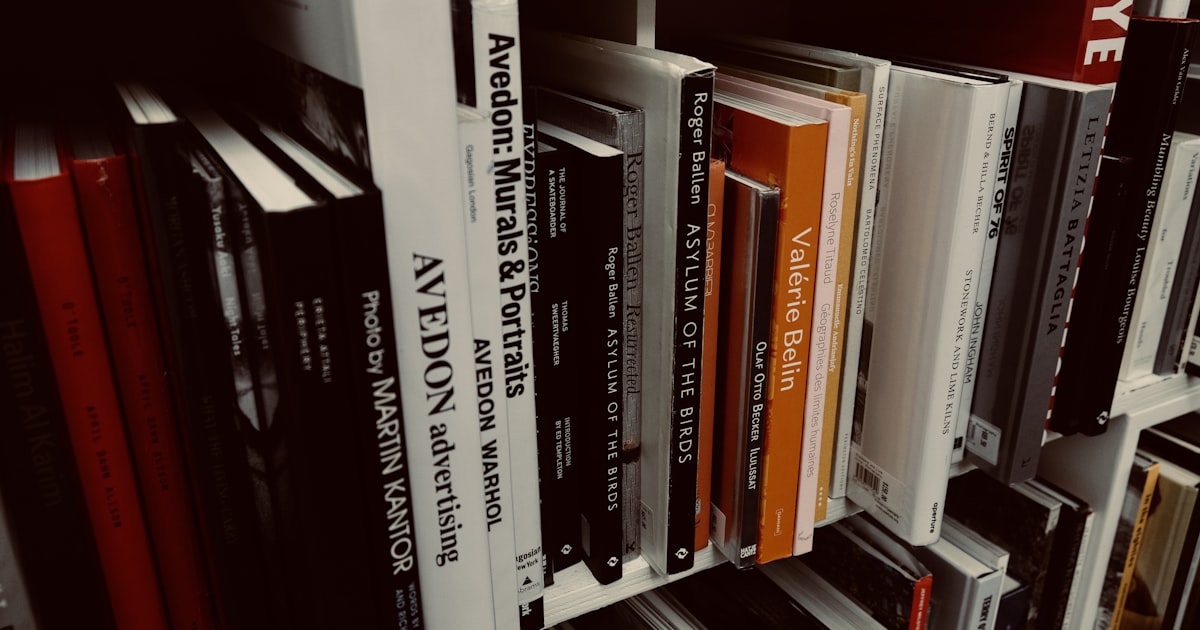 books on white wooden shelf