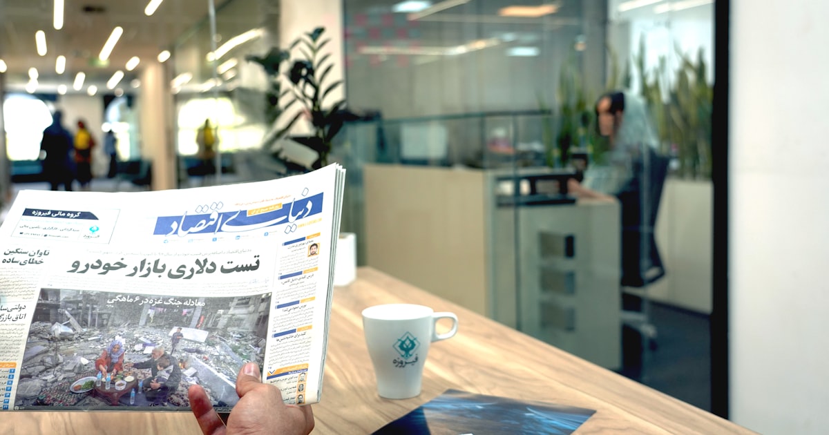 a person reading a newspaper in an office