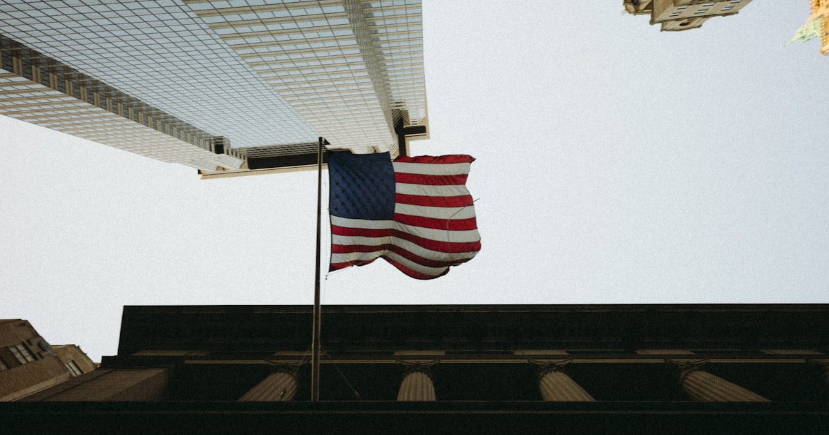 An american flag flying in front of a building